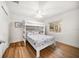Bright bedroom with a bunk bed, hardwood floors and a large window at 745 Bruce Ave, Clearwater Beach, FL 33767