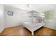 Bright bedroom with a bunk bed, hardwood floors and a decorative round window at 745 Bruce Ave, Clearwater Beach, FL 33767