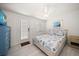 Bright bedroom boasts a ceiling fan and coastal-themed bedding at 745 Bruce Ave, Clearwater Beach, FL 33767
