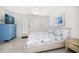 Bright bedroom boasts a ceiling fan and coastal-themed bedding at 745 Bruce Ave, Clearwater Beach, FL 33767