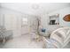 Bright dining area with wicker chairs, tile floors, and sunlit windows at 745 Bruce Ave, Clearwater Beach, FL 33767