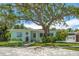 Charming single-story home features a welcoming front yard with mature landscaping at 745 Bruce Ave, Clearwater Beach, FL 33767