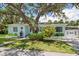 Charming single-story home features a welcoming front yard with mature landscaping at 745 Bruce Ave, Clearwater Beach, FL 33767
