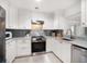 This bright, modern kitchen features stainless appliances and custom cabinetry at 745 Bruce Ave, Clearwater Beach, FL 33767