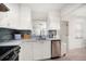Charming kitchen features white cabinets, stainless steel appliances, and stylish backsplash at 745 Bruce Ave, Clearwater Beach, FL 33767