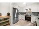 Well-lit kitchen with white cabinets, stainless steel appliances, and sleek countertops at 745 Bruce Ave, Clearwater Beach, FL 33767