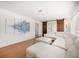 Bright living room features a white sectional sofa, wood floors, and unique fish artwork at 745 Bruce Ave, Clearwater Beach, FL 33767