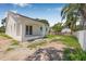 A view of the home's backyard featuring a patio, lawn, and partial fencing at 7617 Alvina St, Tampa, FL 33625