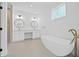 Modern bathroom with double vanity, soaking tub, and walk-in shower at 7617 Alvina St, Tampa, FL 33625