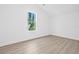 Spacious bedroom with light wood floors, large window and ample natural light at 7617 Alvina St, Tampa, FL 33625