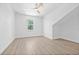 Bright bedroom features a ceiling fan, light wood floors, and a large window at 7617 Alvina St, Tampa, FL 33625