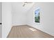 Bright bedroom features a ceiling fan, light wood floors, and a large window at 7617 Alvina St, Tampa, FL 33625