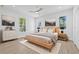 Modern bedroom with hardwood floors, natural lighting, and a ceiling fan at 7617 Alvina St, Tampa, FL 33625