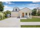 Charming two-story home with a well-manicured lawn and a cozy front porch at 7617 Alvina St, Tampa, FL 33625