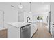 Modern kitchen featuring a white island with quartz countertops, stainless steel appliances, and hardwood floors at 7617 Alvina St, Tampa, FL 33625