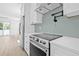 Modern kitchen with stainless steel appliances and green tile backsplash at 7617 Alvina St, Tampa, FL 33625
