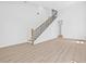Spacious living area with wood floors and modern staircase with black steel rods at 7617 Alvina St, Tampa, FL 33625