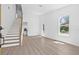 Open living space boasting wood floors, a staircase, and large windows at 7617 Alvina St, Tampa, FL 33625