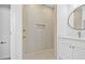 Modern shower with herringbone tile surround, gold fixtures, and a recessed niche at 7617 Alvina St, Tampa, FL 33625