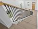 Stylish staircase with wood treads, black metal balusters, and natural light at 7617 Alvina St, Tampa, FL 33625