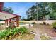 Spacious backyard showcasing a swimming pool, brick patio, lush greenery, and mature trees at 7710 Jackson Springs Rd, Tampa, FL 33615