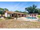 Aerial view of a backyard with an in-ground swimming pool, patio area, and storage shed at 7710 Jackson Springs Rd, Tampa, FL 33615