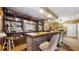 Entertain in this cozy bar area featuring ample seating and storage for beverages at 7710 Jackson Springs Rd, Tampa, FL 33615