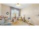 Bright bedroom featuring a ceiling fan, neutral decor, and a large window at 7710 Jackson Springs Rd, Tampa, FL 33615
