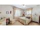 Cozy bedroom with white furniture, matching floral bedding, and charming window treatments for a quaint aesthetic at 7710 Jackson Springs Rd, Tampa, FL 33615