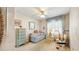 Charming bedroom featuring neutral décor, a ceiling fan, and a bright window at 7710 Jackson Springs Rd, Tampa, FL 33615