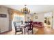 Charming dining room with parquet floors, a chandelier and dark wood furniture, adjacent to a patio at 7710 Jackson Springs Rd, Tampa, FL 33615