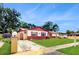 Charming single Gathering home with well-maintained lawn, eye-catching exterior details and manicured landscape at 7710 Jackson Springs Rd, Tampa, FL 33615