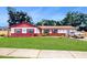Charming single Gathering home with well-maintained lawn, eye-catching exterior and manicured landscape at 7710 Jackson Springs Rd, Tampa, FL 33615
