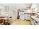 Eat-in kitchen features white cabinets and ample countertop space for preparing meals at 7710 Jackson Springs Rd, Tampa, FL 33615