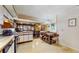Kitchen with dining table, breakfast bar, and white cabinets for storage at 7710 Jackson Springs Rd, Tampa, FL 33615