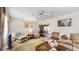 Cozy living room with neutral carpet and decor, flowing into an adjacent dining area at 7710 Jackson Springs Rd, Tampa, FL 33615