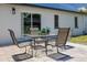 Back patio with table, chairs, and view of the grassy lawn at 7815 Shadow Run Dr, Largo, FL 33773