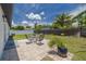 Spacious fenced back yard with patio, seating, and well-maintained landscaping at 7815 Shadow Run Dr, Largo, FL 33773