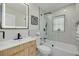 Updated bathroom with a modern vanity, glass enclosed shower and tub combination at 7815 Shadow Run Dr, Largo, FL 33773