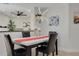 Elegant dining room featuring modern chandelier, table and seating for four at 7815 Shadow Run Dr, Largo, FL 33773