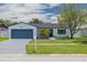 Charming single-story home featuring a well-maintained lawn, a blue painted driveway and a mailbox at 7815 Shadow Run Dr, Largo, FL 33773