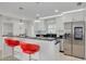 Bright kitchen featuring white cabinets, granite countertops, stainless steel appliances, and bar seating at 7815 Shadow Run Dr, Largo, FL 33773