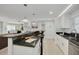 Modern kitchen with stainless steel appliances and breakfast bar that opens to the adjacent dining and living spaces at 7815 Shadow Run Dr, Largo, FL 33773