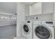 Convenient laundry area with modern washer and dryer, with access to the garage at 7815 Shadow Run Dr, Largo, FL 33773