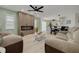 Comfortable living room flowing into a dining area, complemented by a wall with an electric fireplace at 7815 Shadow Run Dr, Largo, FL 33773