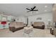 Comfortable living room with modern ceiling fan, warm furniture, and open view to the kitchen at 7815 Shadow Run Dr, Largo, FL 33773