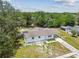 Aerial view of the home with a carport and a neatly maintained yard, offering a sense of space and privacy at 9259 Marler Rd, Spring Hill, FL 34608