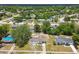 Charming single story home with front yard landscaping surrounded by lush trees and other residences at 9259 Marler Rd, Spring Hill, FL 34608