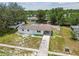 Aerial view of a home with a carport, surrounded by a well-manicured lawn at 9259 Marler Rd, Spring Hill, FL 34608