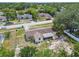 Aerial view of the home with street view, lawn and surrounded by trees and neighborhood homes at 9259 Marler Rd, Spring Hill, FL 34608